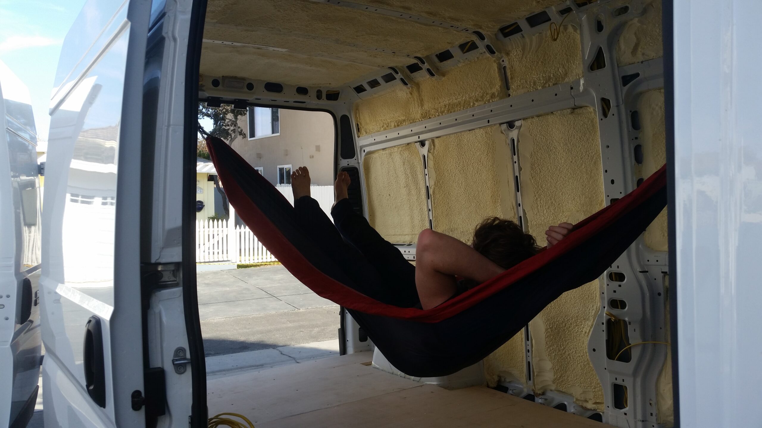 Hammock strung inside the bare cargo van during the build