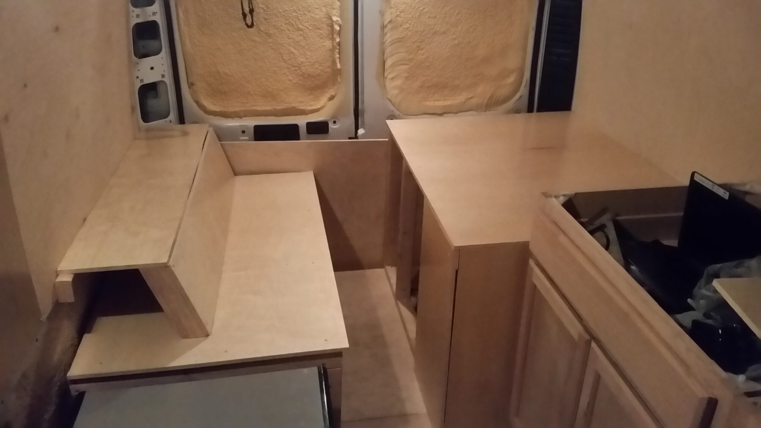 Plywood bench and storage inside the van