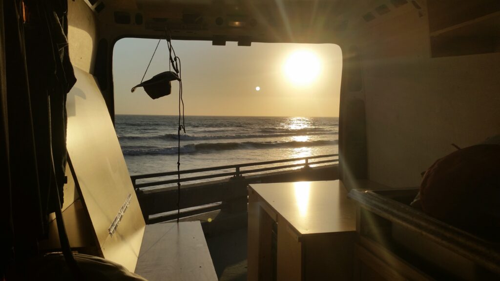 Inside the van at sunset over the ocean, 2016