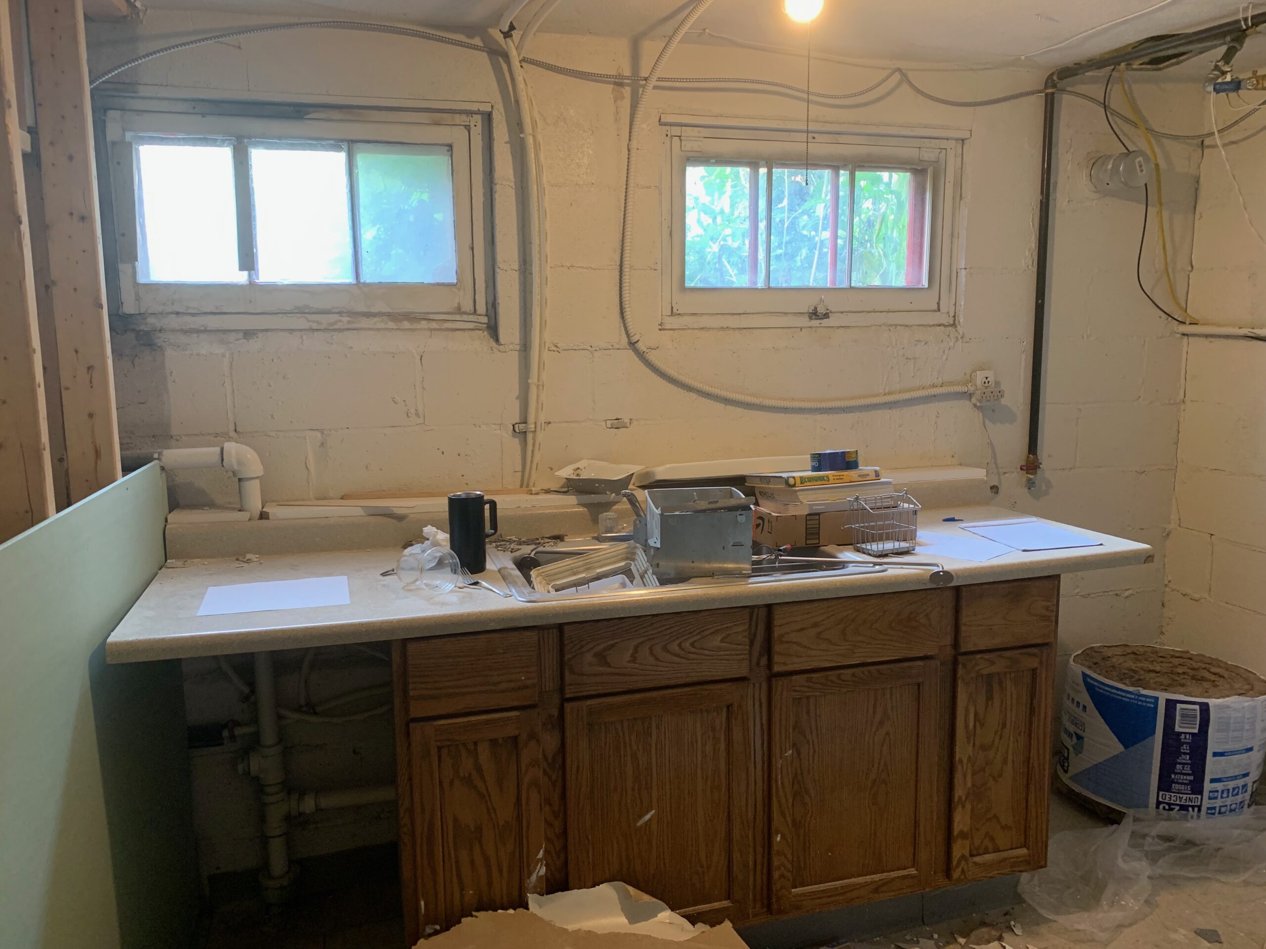 Original kitchen with old cabinets during demolition prep