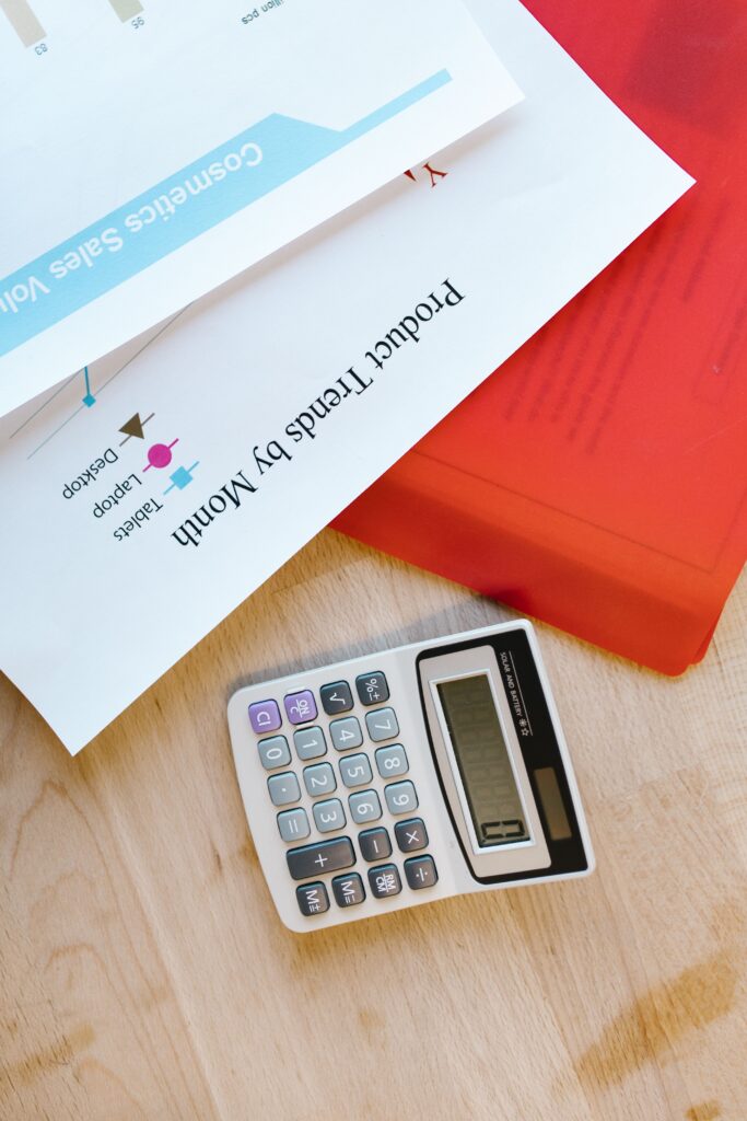 Stock photo of a calculator, cash, and receipt on a desk for budgeting