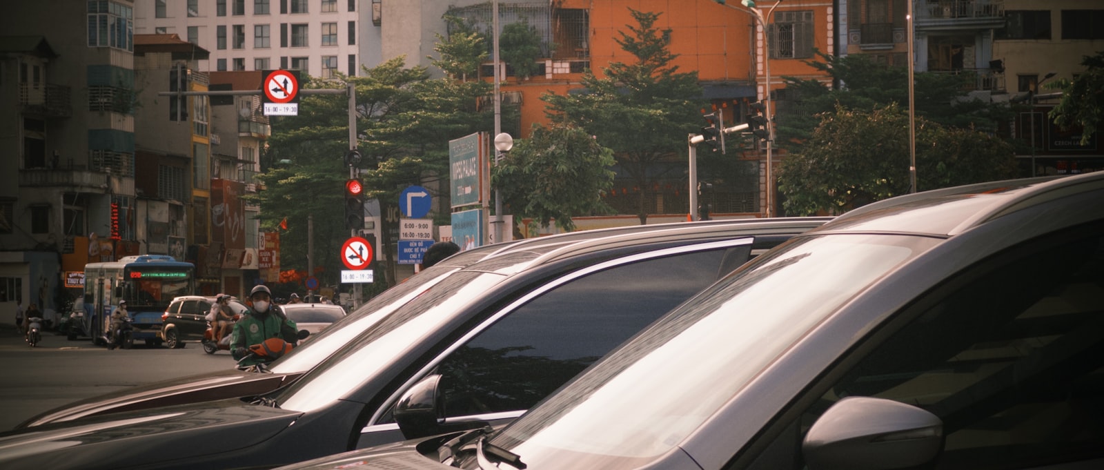 Cars moving slowly through traffic on a city street