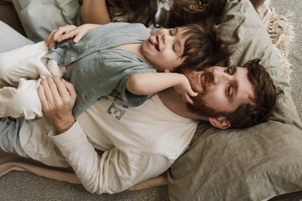 Stock photo of a happy family taking a selfie surrounded by moving boxes
