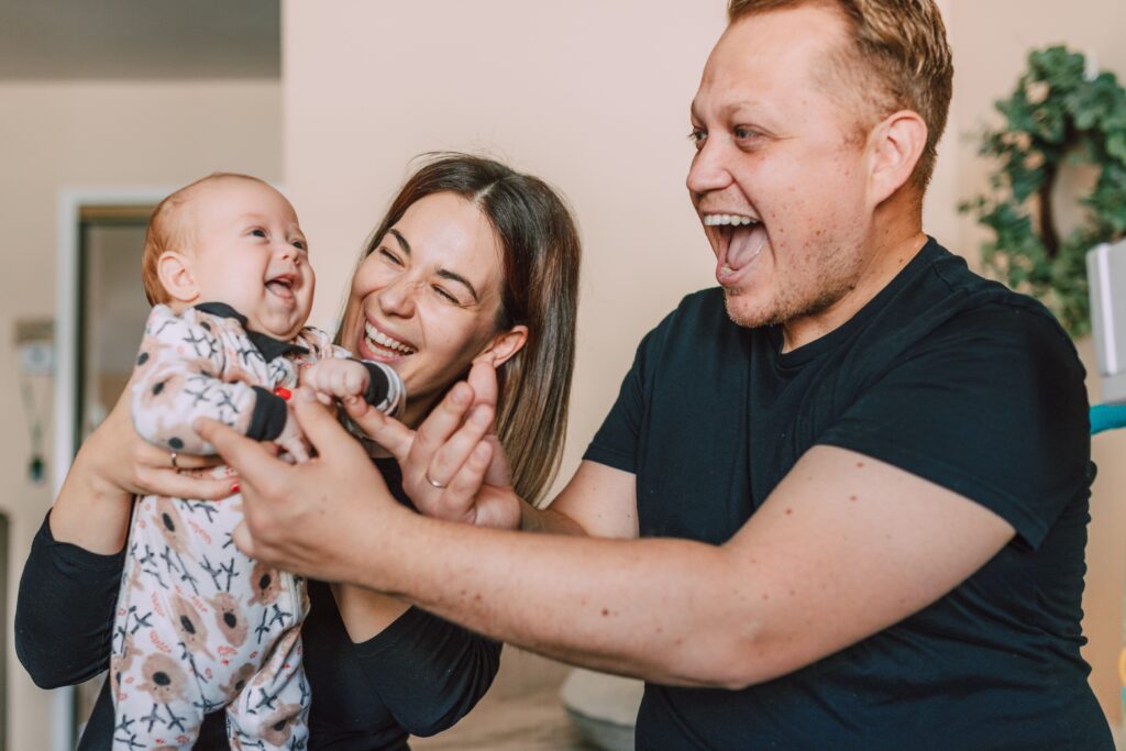 Stock photo of a family celebrating together in front of a brick house