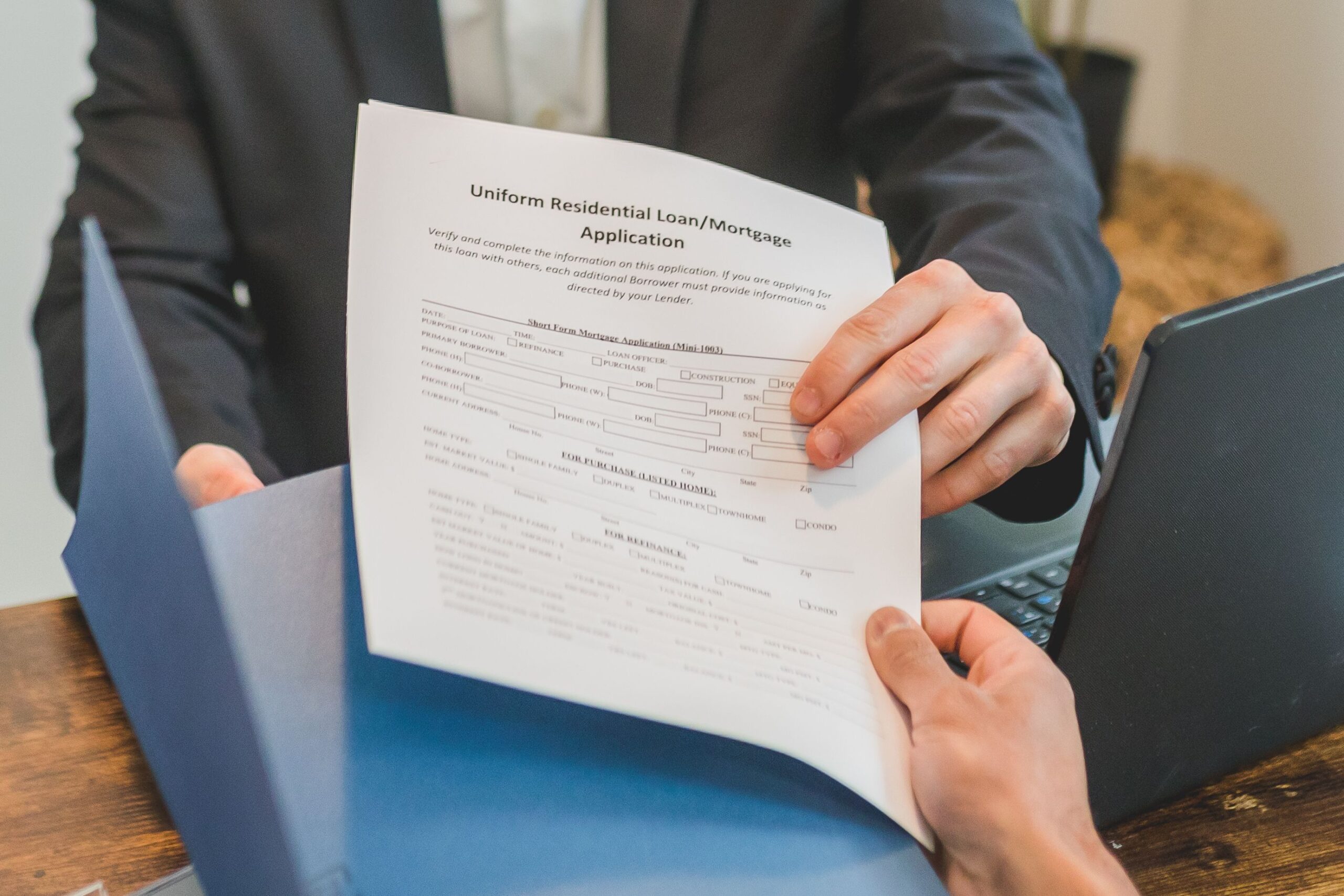 Stock photo of a person reviewing a mortgage application document