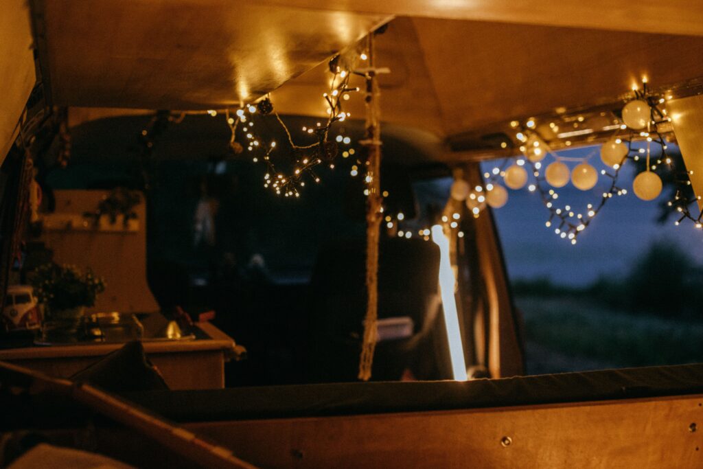 The inside of a small camper van set up as a living space