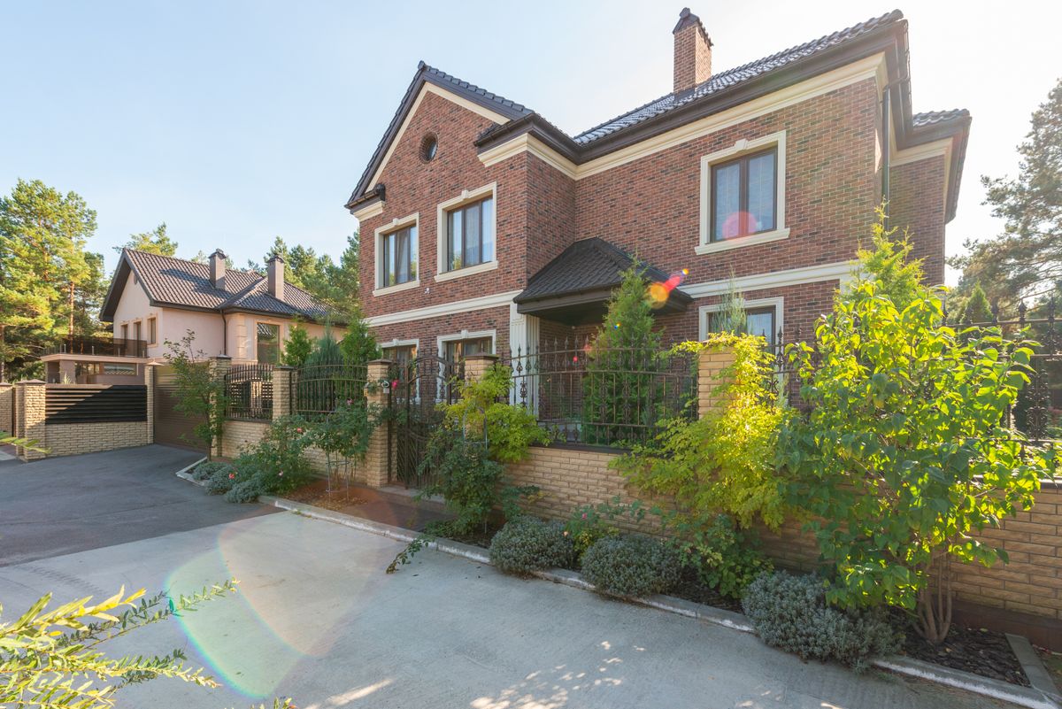 Stock photo of a brick house with a front garden