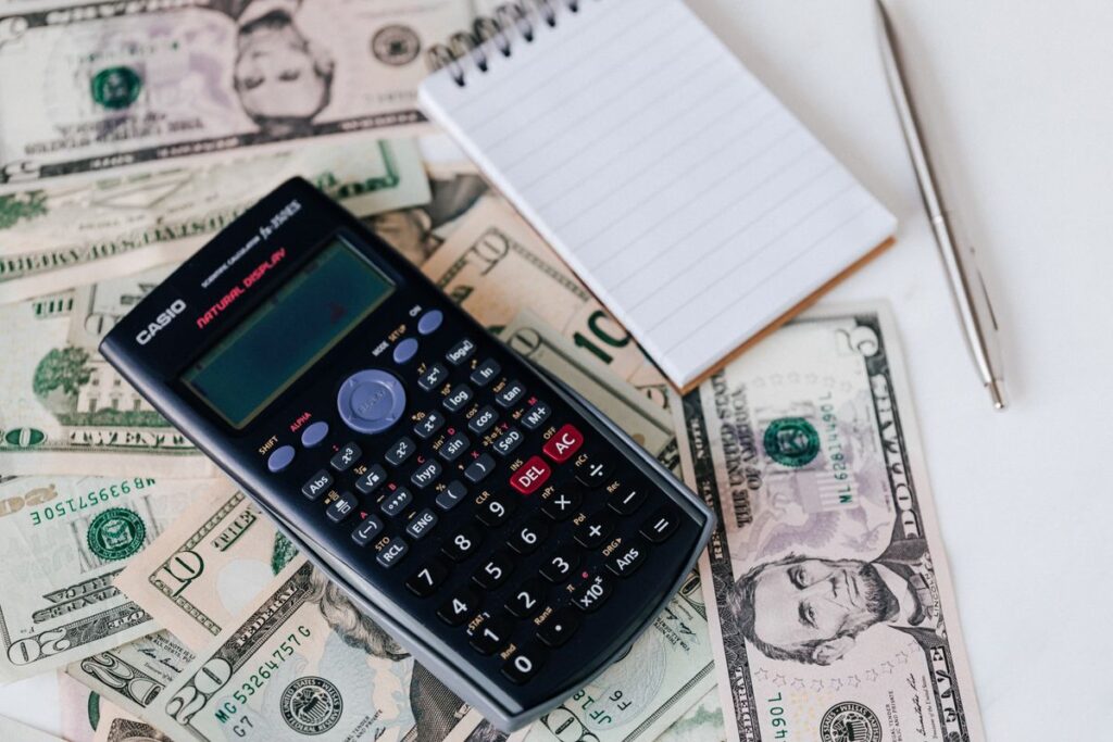 Stock photo of a calculator and notepad on a desk