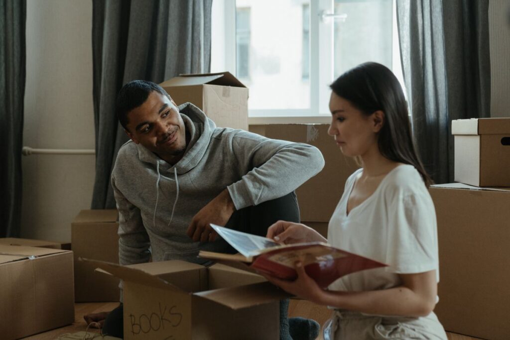 Stock photo of a couple unpacking moving boxes in a new home