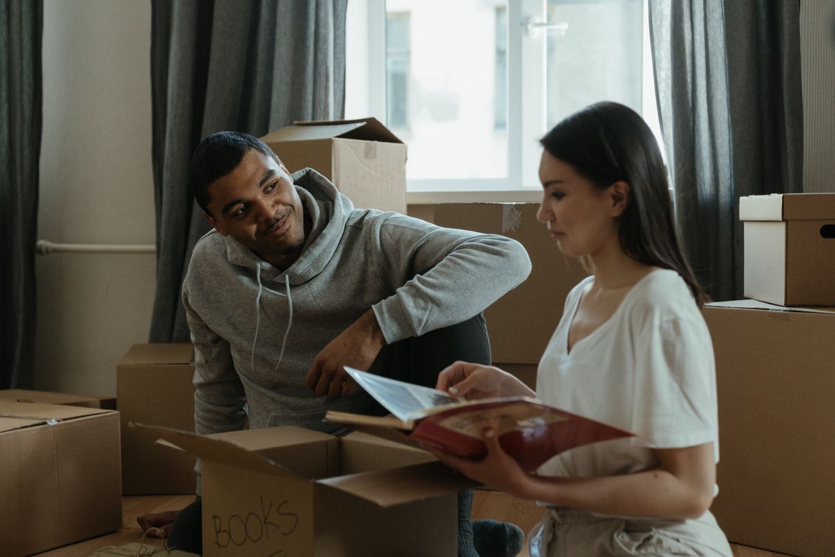 Stock photo of a couple unpacking moving boxes in a new home