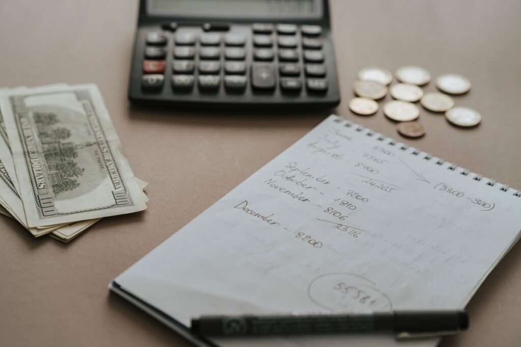 Stock photo of a desk with budgeting paperwork and a laptop