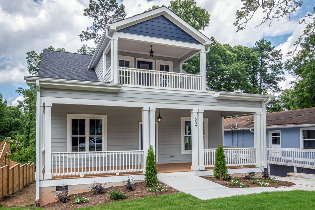 Stock photo of a new two-family home with stacked front porches