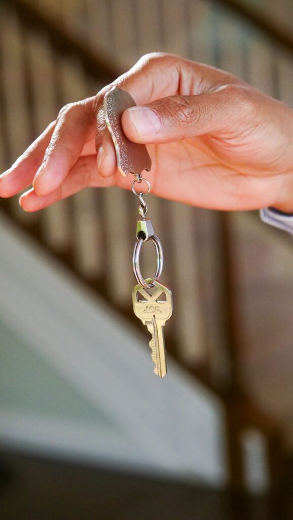 Stock photo of a hand holding a house key