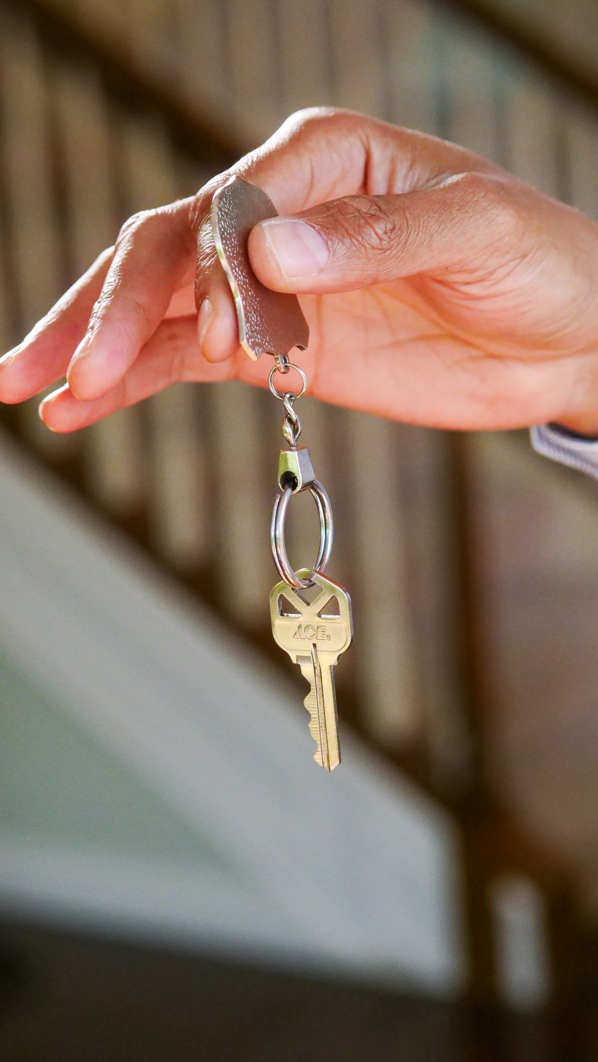 Stock photo of a hand holding a house key