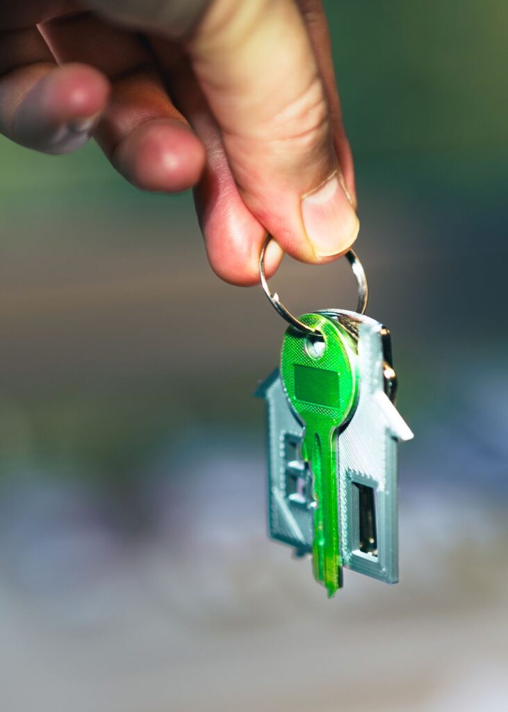 Stock photo of a house-shaped keychain held up in sunlight