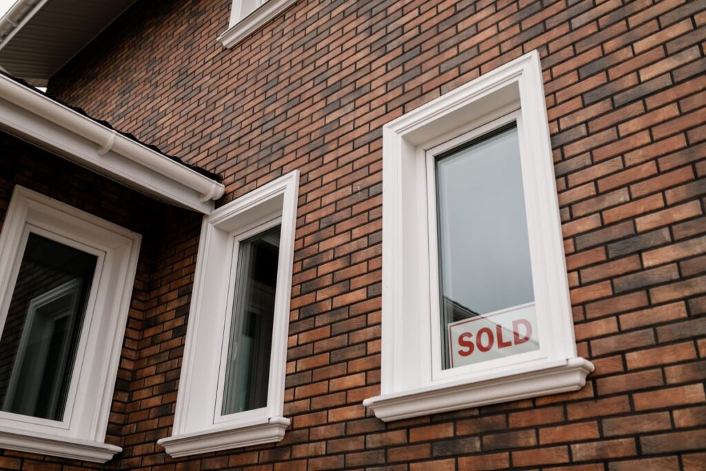 Stock photo of a sold sign in front of a house