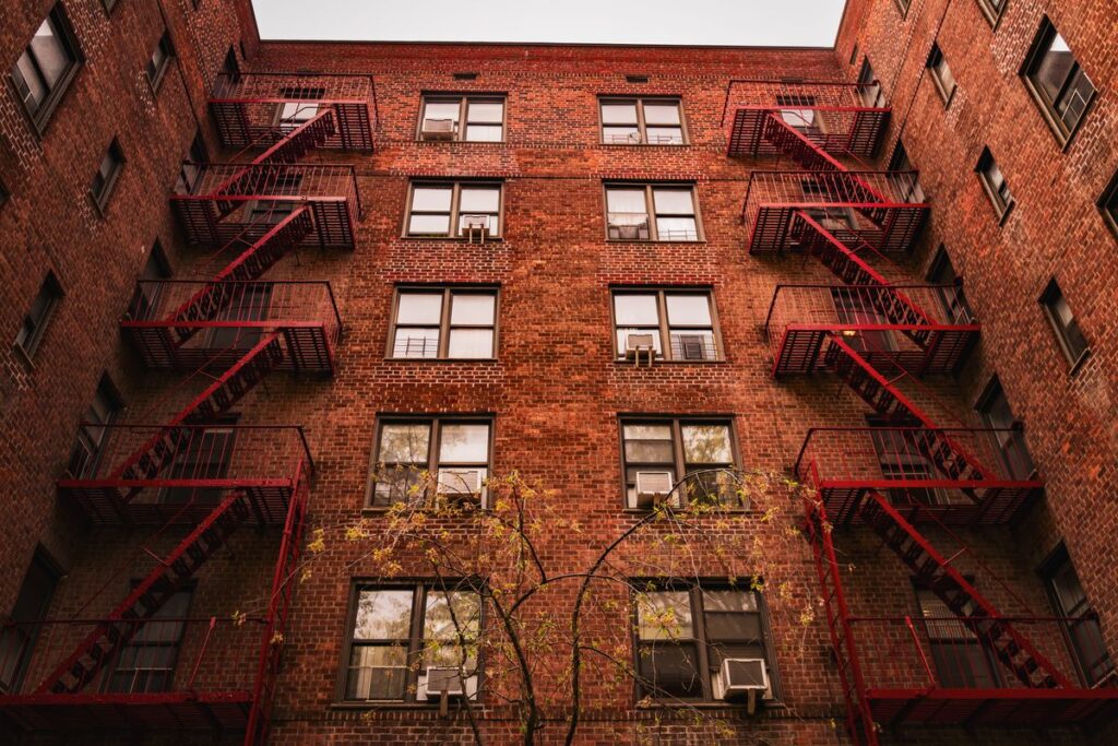 Stock photo of a New York brick apartment building with fire escapes