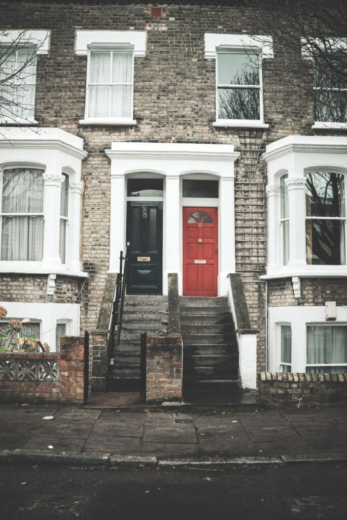 Stock photo of brick rowhouses with red and black front doors