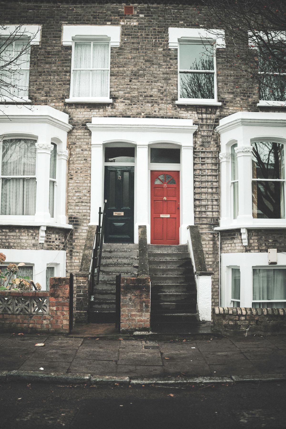 Stock photo of brick rowhouses with red and black front doors