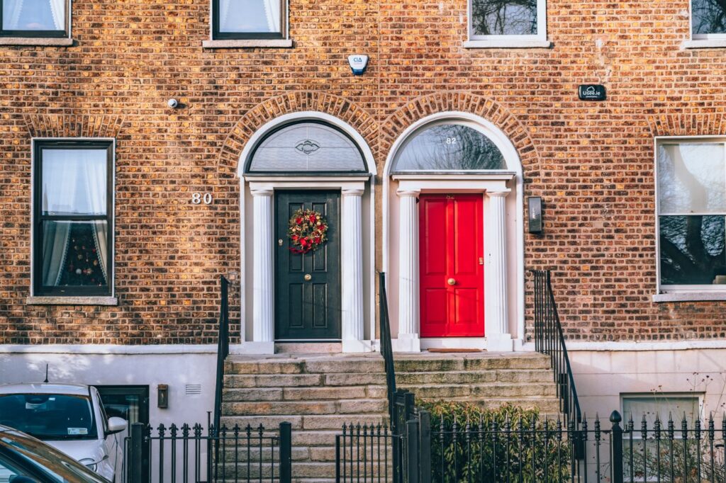 A brick building with two separate front doors side by side