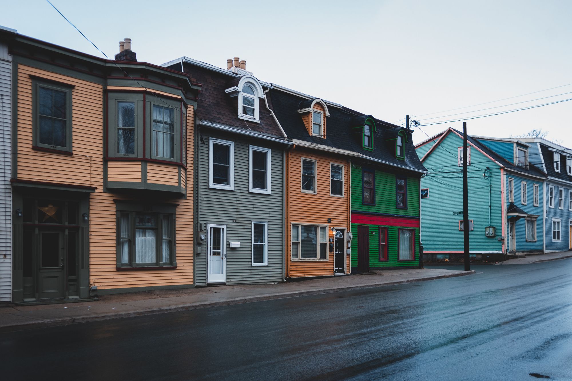 Stock photo of colorful wooden rowhouses on a wet street