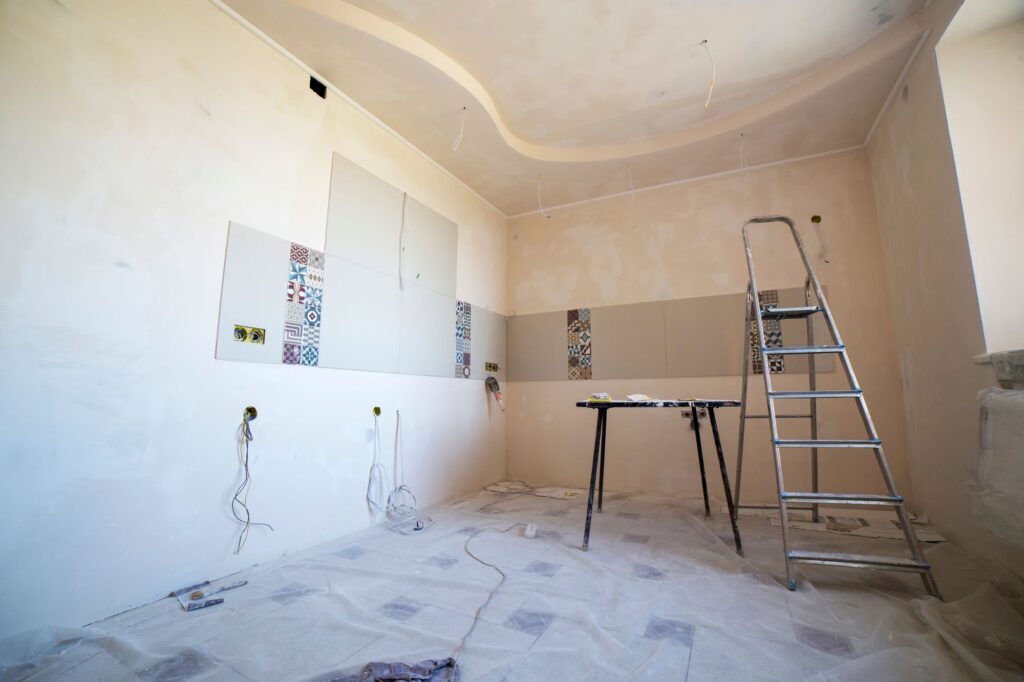 Stock photo of an empty room under renovation with a ladder and bare walls