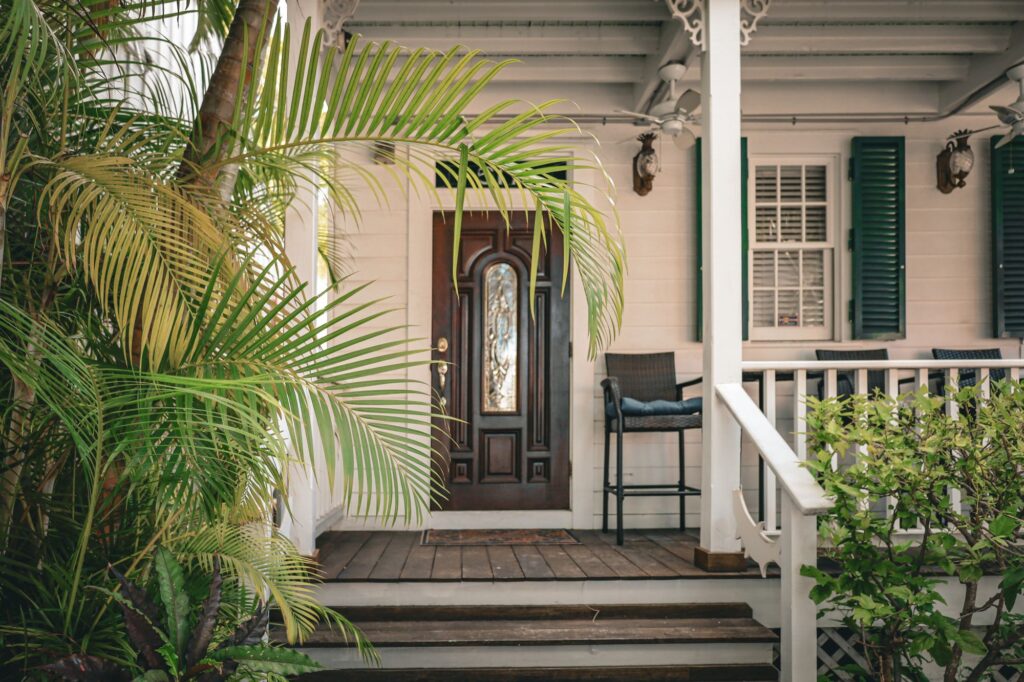 Stock photo of a front porch with a chair and a screen door