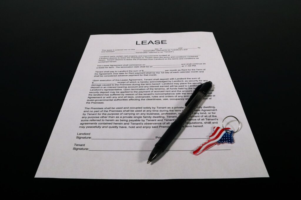 Stock photo of a printed lease agreement with a pen and a small key