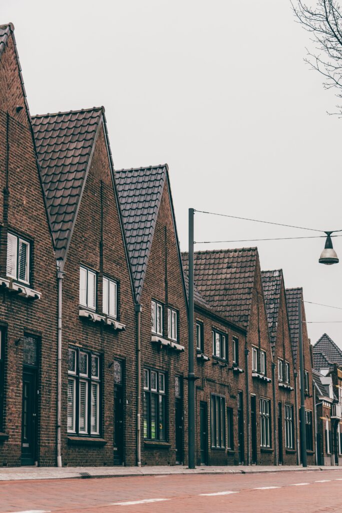 Row of traditional brick townhouses along a quiet street
