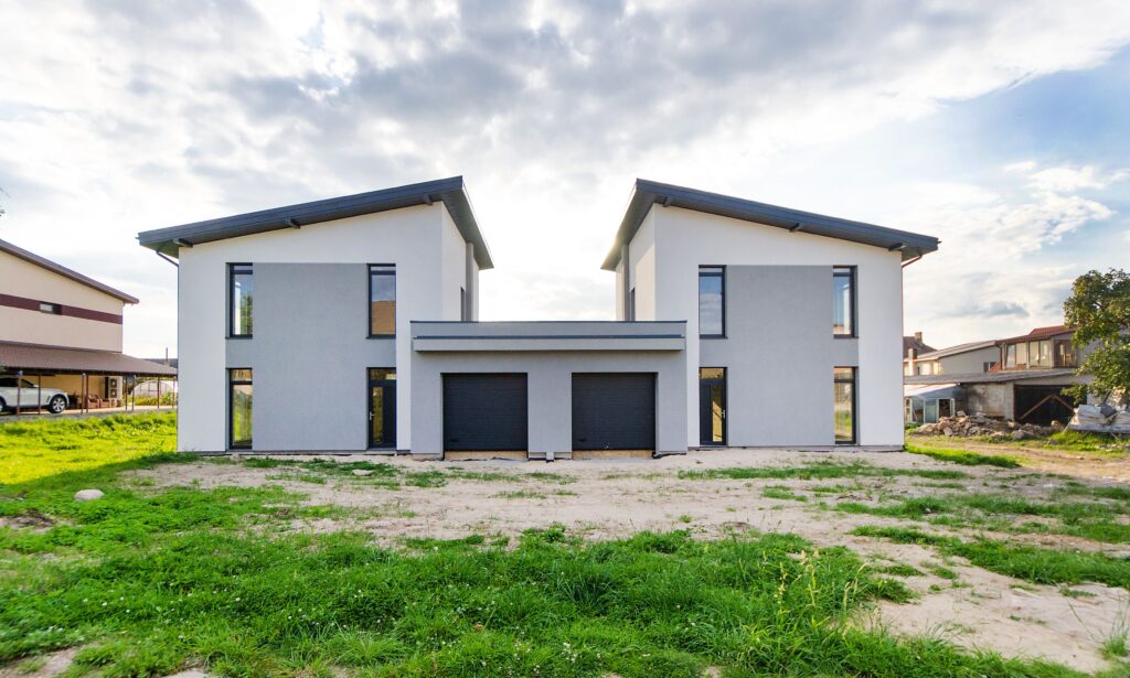 Front view of a modern side-by-side duplex with matching symmetrical facades