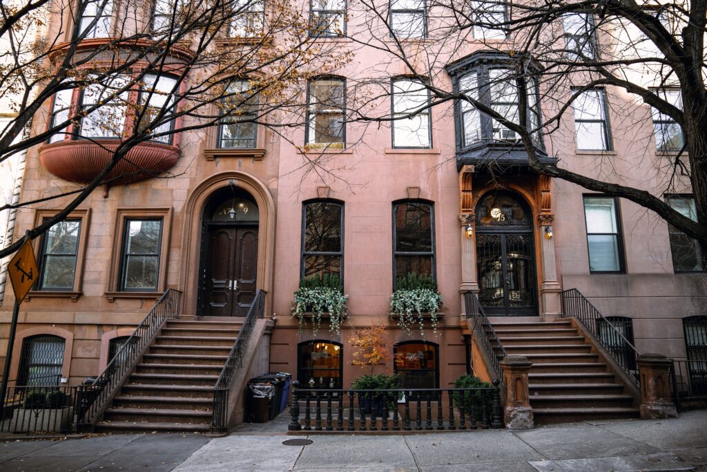 Row of Brooklyn brownstones on a tree-lined street in autumn