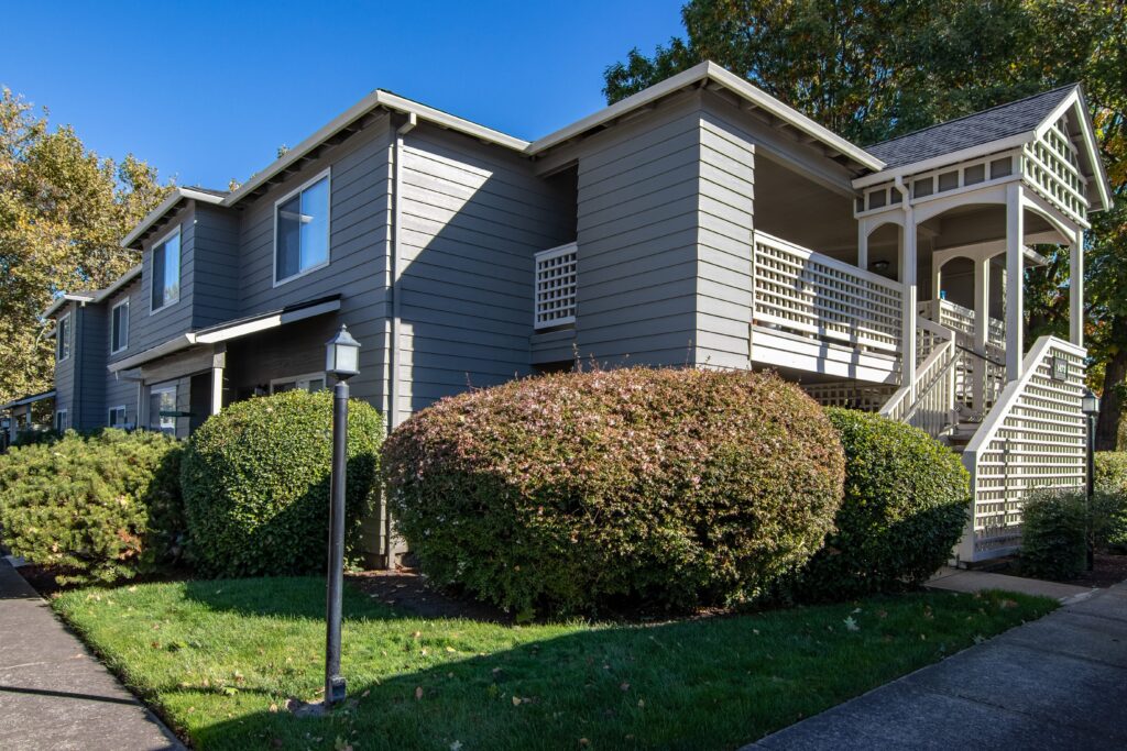 Landscaped bushes in front of a modern small apartment building in Medford, Oregon