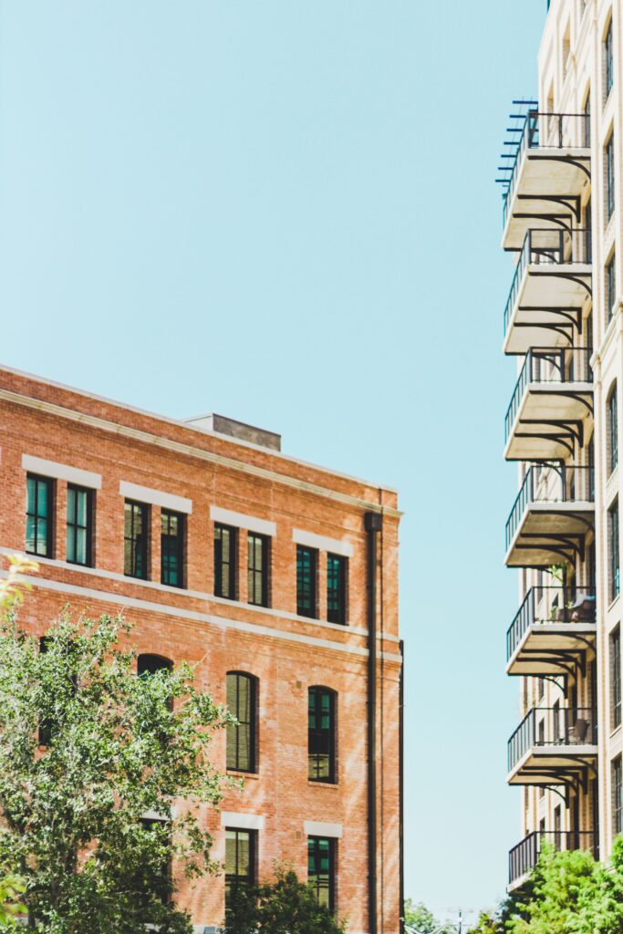 Low-angle view of apartment buildings with balconies against a blue sky in San Antonio