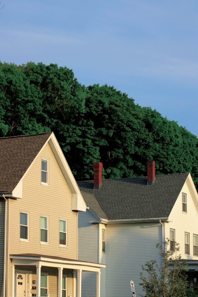 Row of houses with trees in the background on a residential street