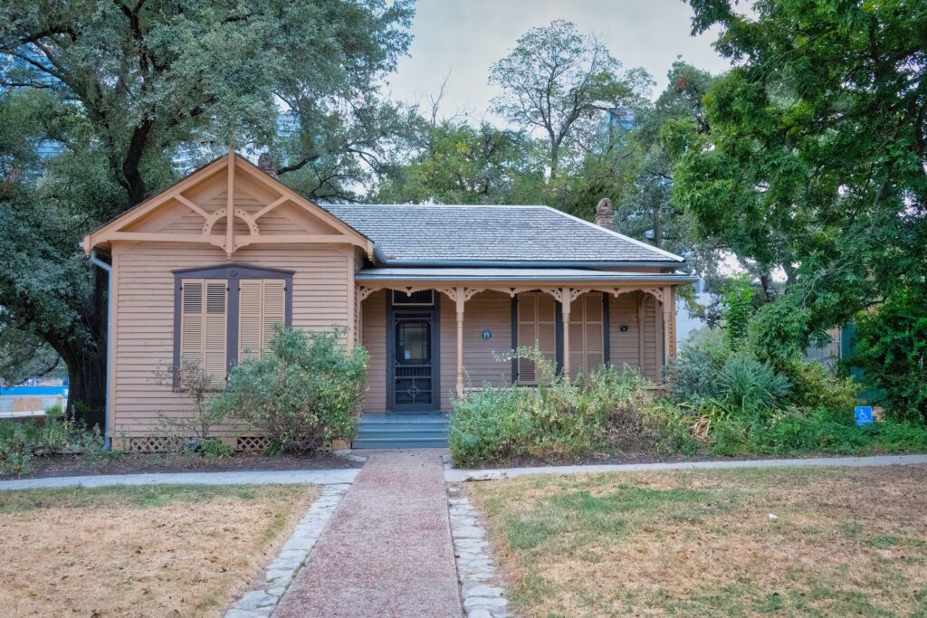 Historic wooden house surrounded by trees in Austin, Texas