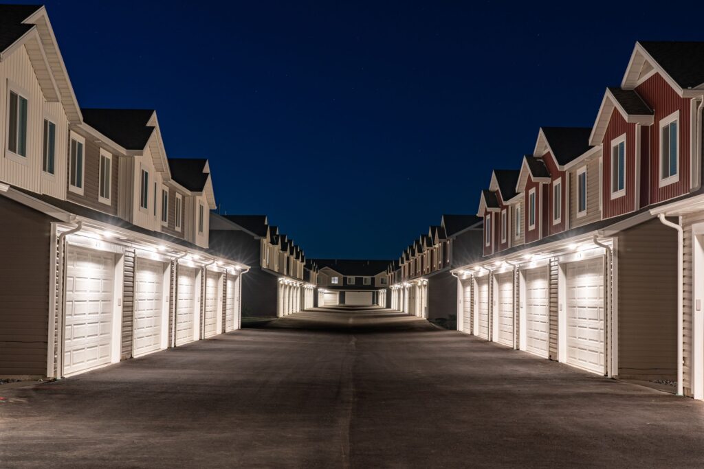 Rows of townhouses lit at night on a quiet street in Hyrum, Utah