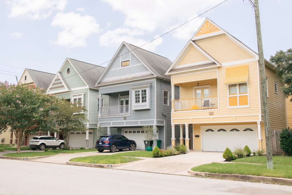 Two-story houses with front porches on a street in Houston Heights, Texas