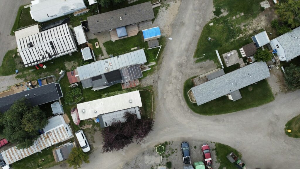 An aerial view of a manufactured-home community with homes along curving streets