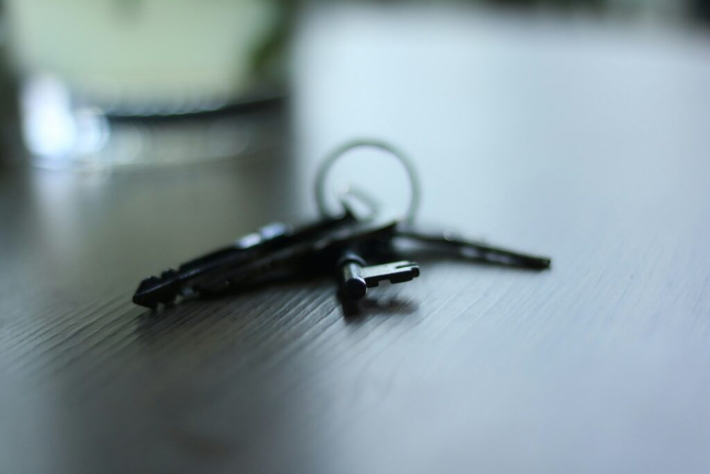 A set of keys on a dark table