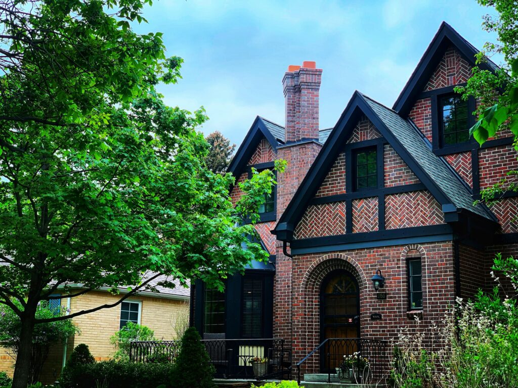 Brick Tudor-style house with trees in Denver, Colorado